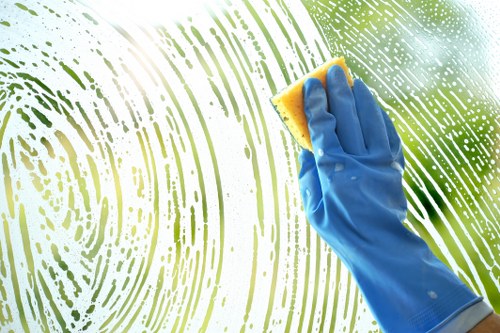Cleaner in protective gloves preparing safe cleaning equipment in a Barnet property