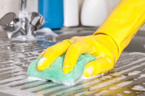 Barnet Cleaner staff member using protective equipment during a professional cleaning task